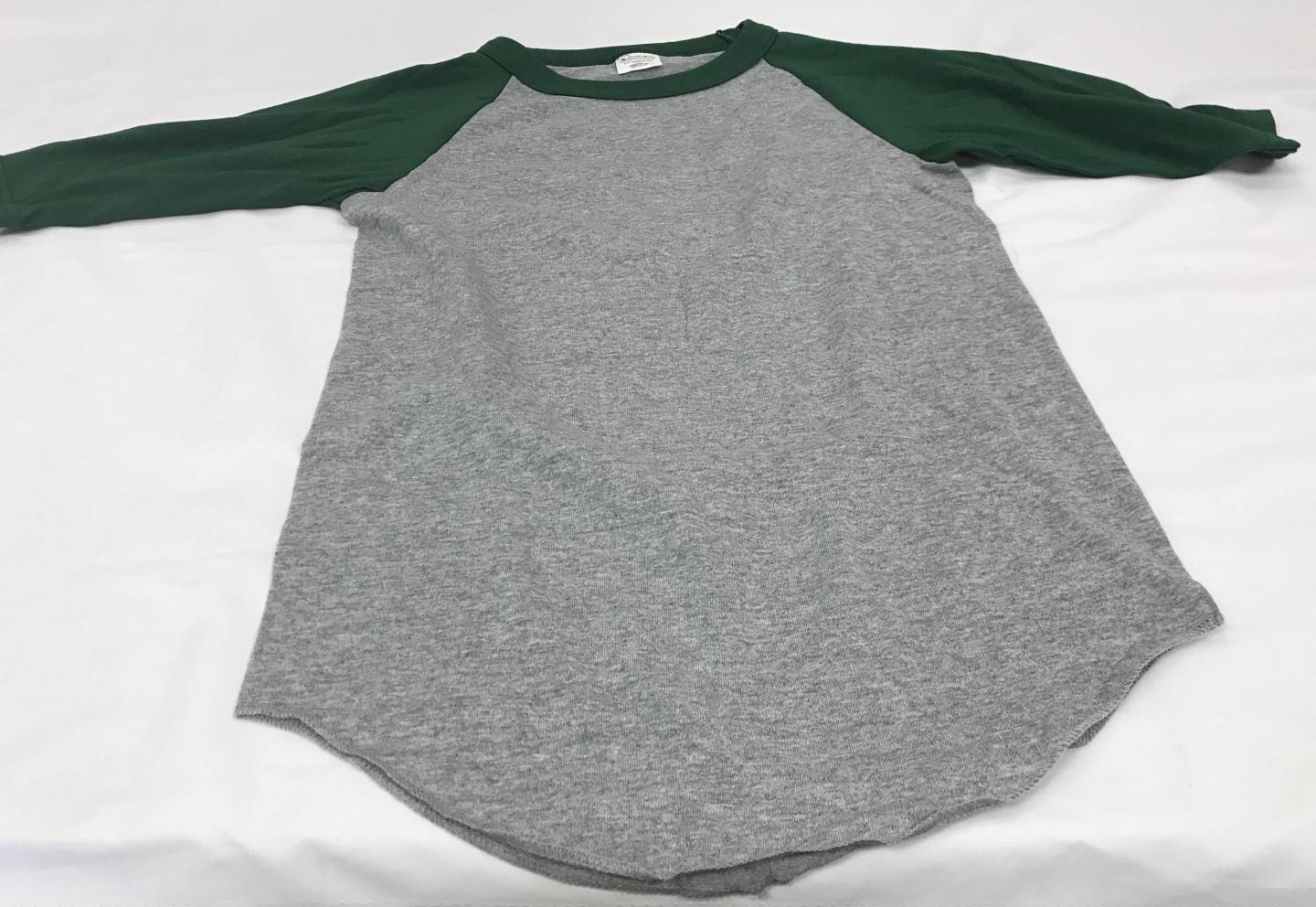 Dark green and gray baseball shirt with Property of St. Thomas the Apostle logo